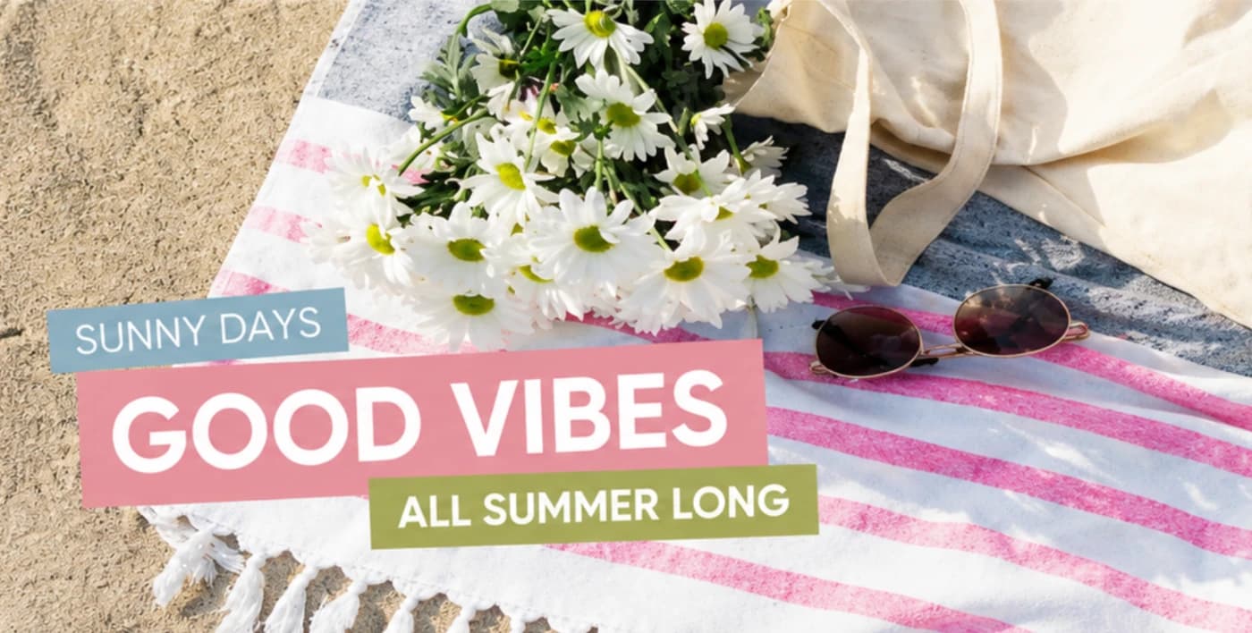 Daisies and sunglasses on a striped beach towel with summer lettering