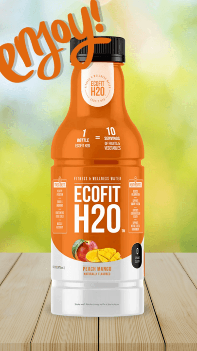 A bottle of peach mango wellness water on a wooden table