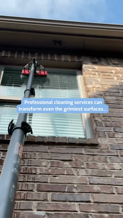 A pole brush cleaning a window on a brick house exterior