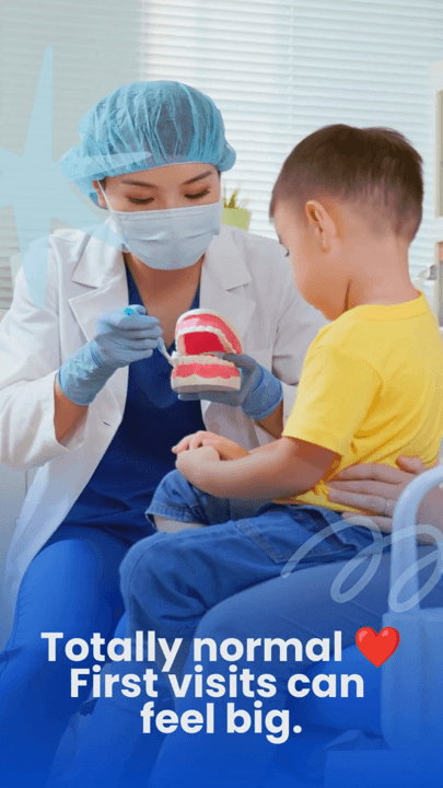 A dentist showing a model of teeth to a young child